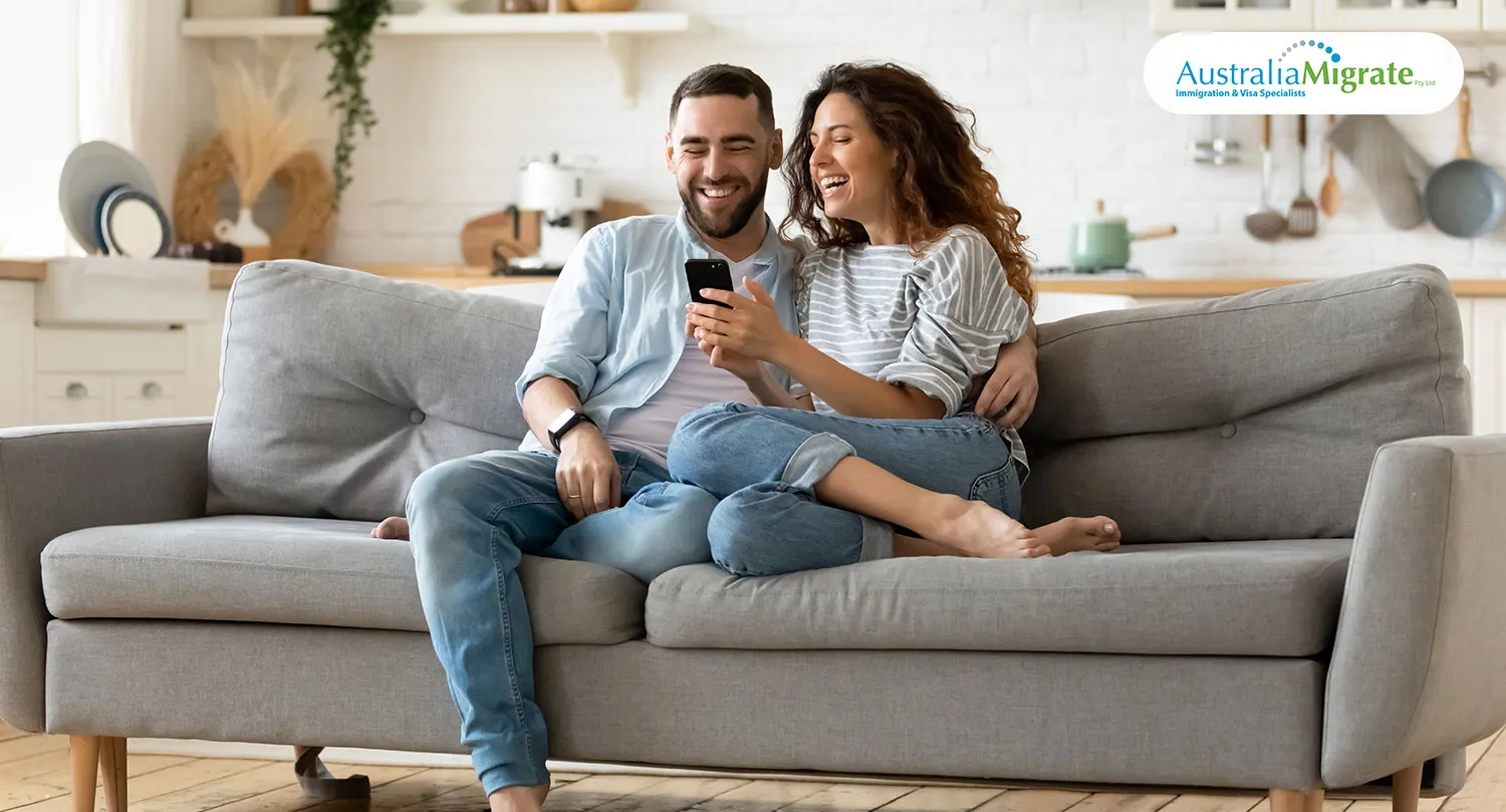A couple reviewing partner visa documents at home, representing the onshore Subclass 820 application process in Australia 2026